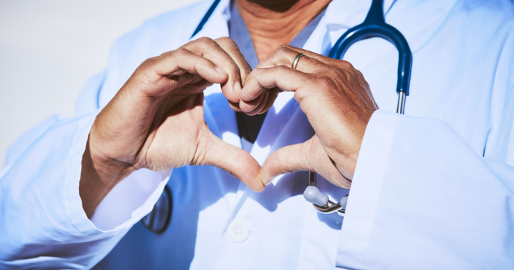 Doctor or vet doing love heart hand sign