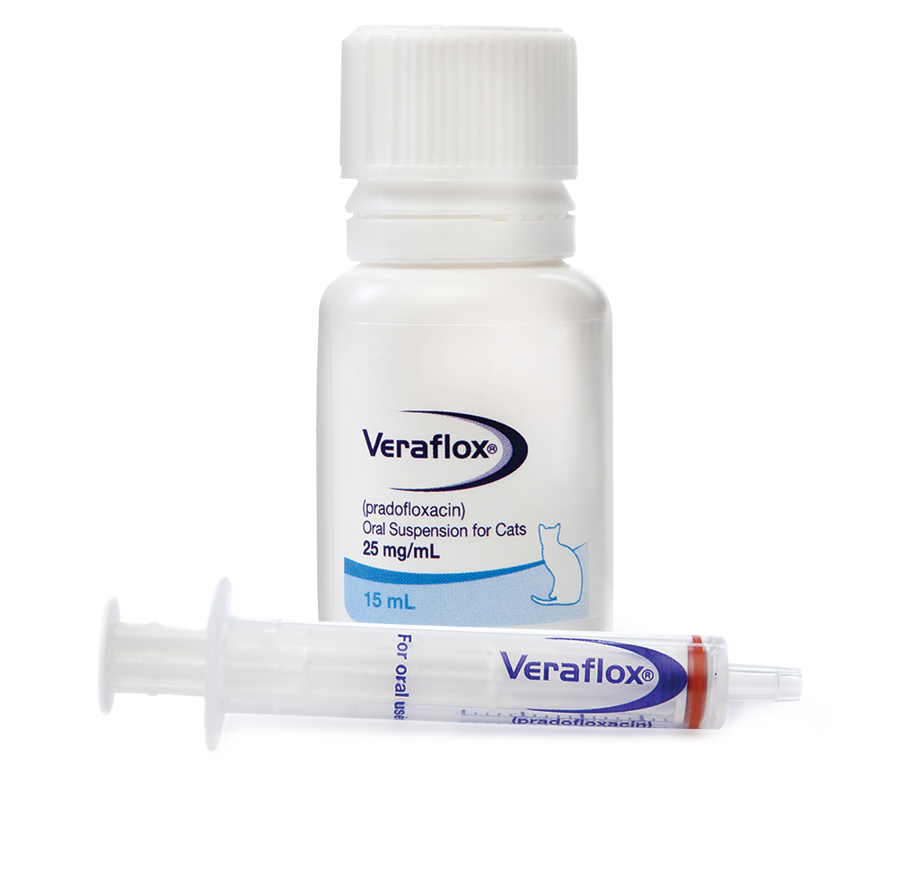 An oral suspension syringe lies in front of a capped bottle of Veraflox.