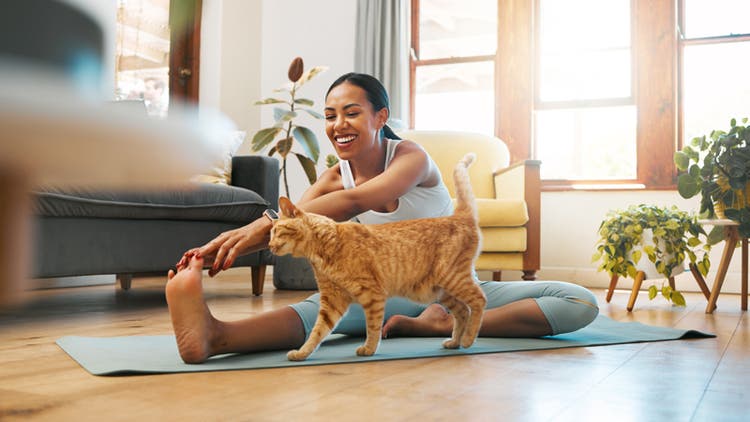 Woman and cat stretching