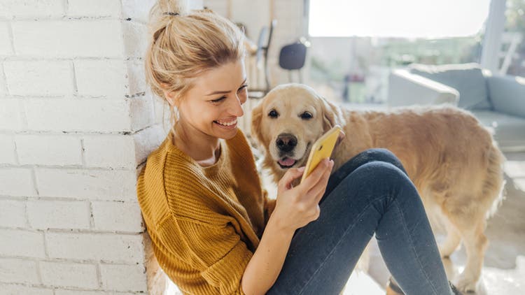 Woman on her phone with dog