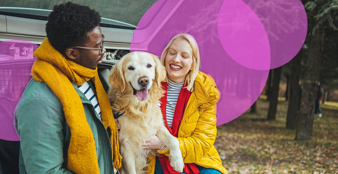 Man and woman with a golden retriever at the back of a car