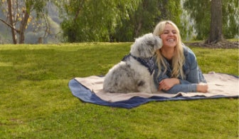 A girl and a dog on a picnic