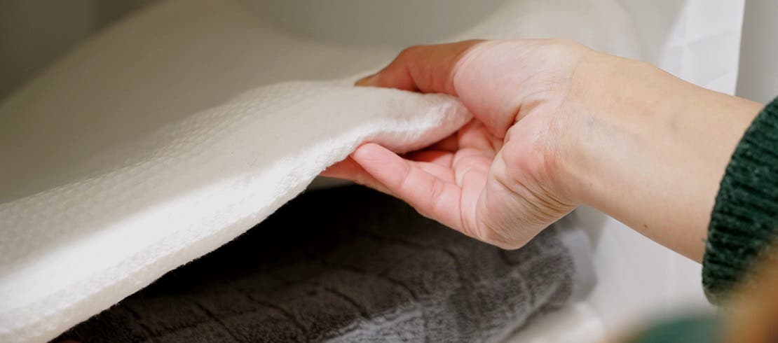 Person cleaning laundry in their home